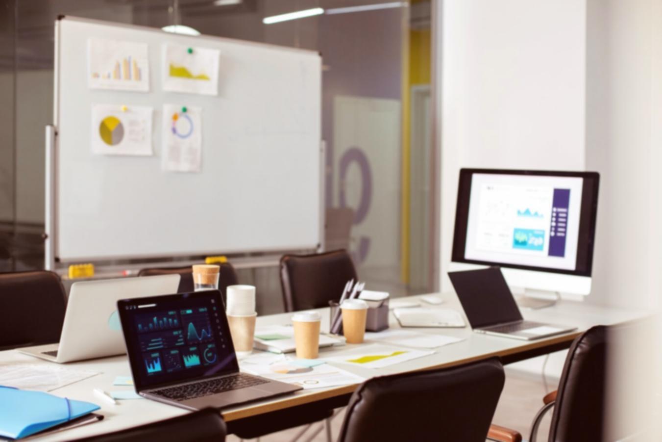 Financial analyst working with multiple data sources on computer screens